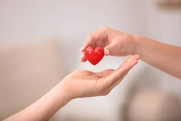 Woman giving heart - community impact